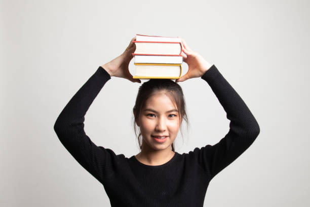 istock Young Asian woman studying  with may books. 1212316818