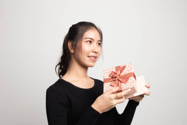 istock Young Asian woman open a gift box. 1212319029