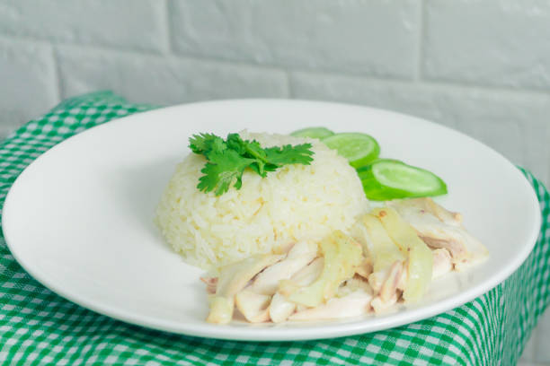 istock Chicken rice with dipping sauce and broth laid on a green tablecloth 1212319192