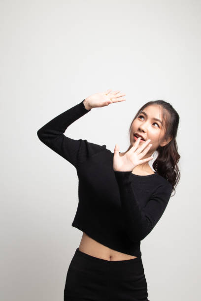 istock Excited young Asian woman look up. 1212319945