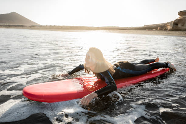 istock Woman swimming on the surfboard 1212320236