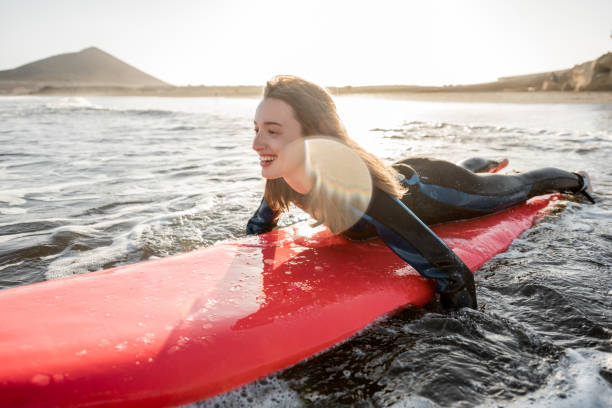 istock Woman swimming on the surfboard 1212320251