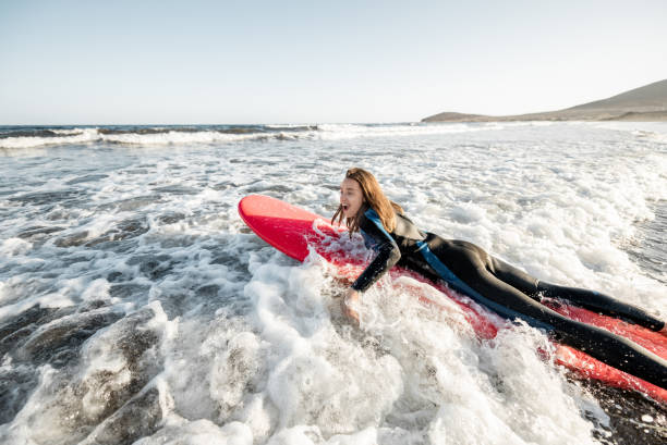 istock Woman swimming on the surfboard 1212320262
