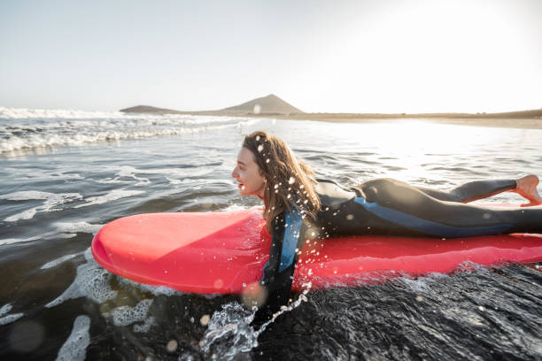 istock Woman swimming on the surfboard 1212320286
