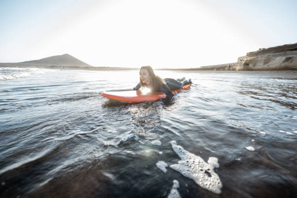 istock Woman swimming on the surfboard 1212320355