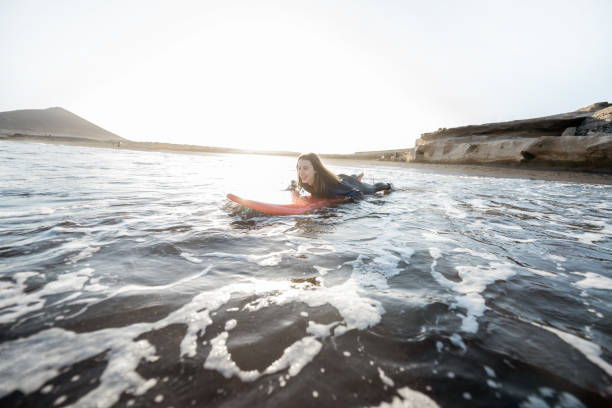 istock Woman swimming on the surfboard 1212320365