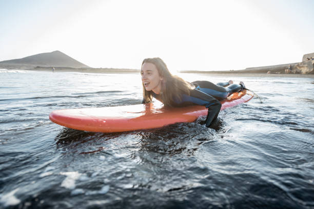 istock Woman swimming on the surfboard 1212320389