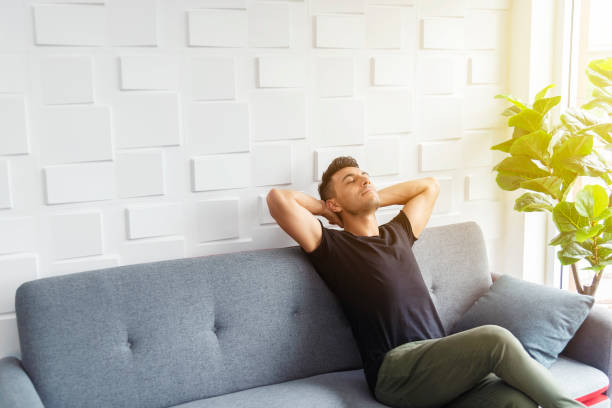Businessman in casual relaxing on sofa with soft sunlight. Happy life. Breaking time. Businessman in casual relaxing on sofa with soft sunlight. Happy life. Breaking time. breath vapor stock pictures, royalty-free photos & images