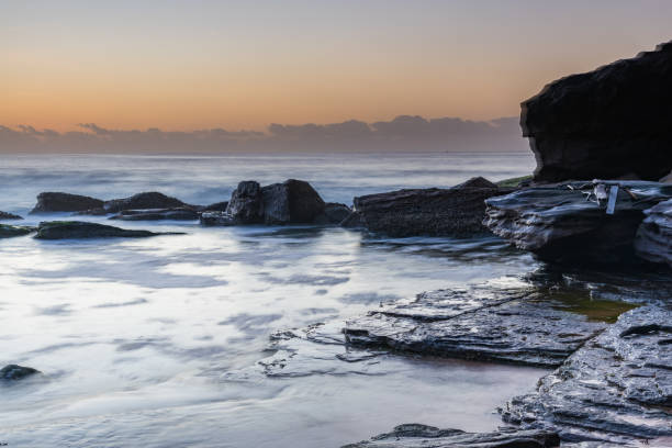 istock Soft Pale Sky Autumn Sunrise by the Sea 1212322418