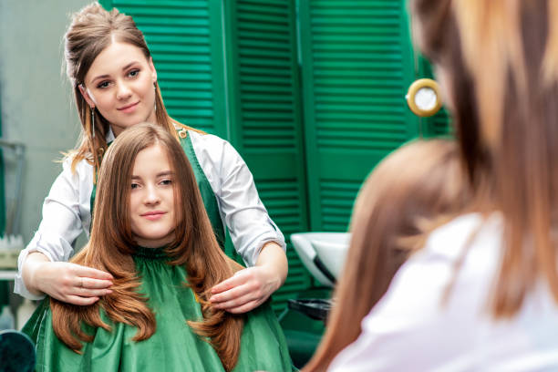 istock Hairdresser makes hairstyle. 1212322421