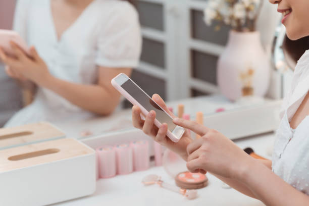 istock Young beautiful woman using cellphone spending time alone in dressing room 1212326313