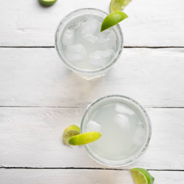 istock Mexican lime margarita cocktail on white background 1212327046