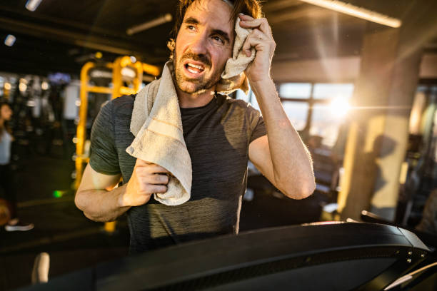 istock Athletic man feeling tired on sports training in a gym. 1212327499