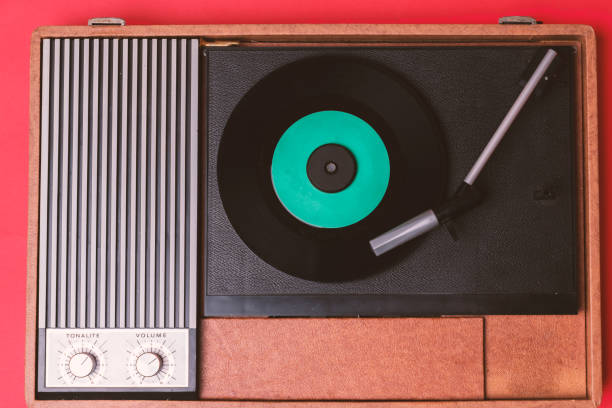 istock Retro vinyl player and recor player on a red background 1212327741