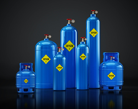 Various sized Oxygen tanks isolated on black.