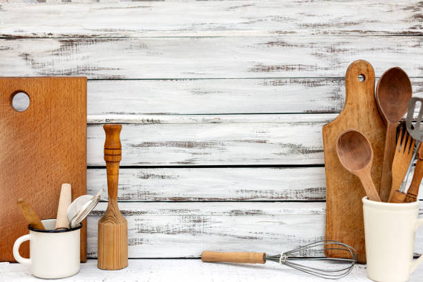 istock Vintage old baking utensils on a white wooden background. 1212328111