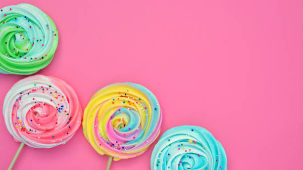 istock Colorful meringue lollipop on a pink background. 1212328416