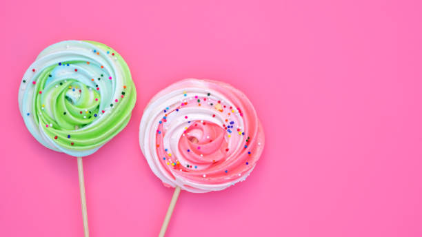istock Colorful meringue lollipop on a pink background. 1212328435