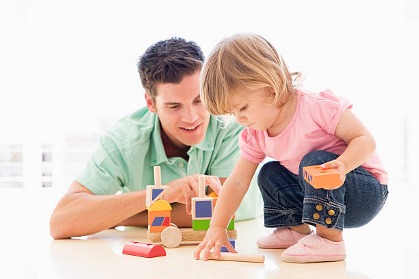 istock Father and daughter indoors playing 121232907