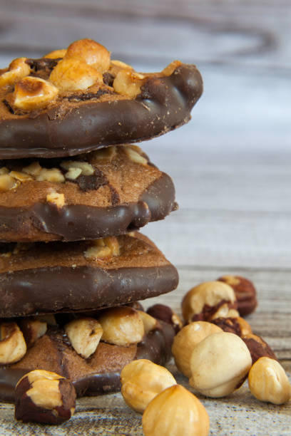 istock Stacked hazelnut and chocolate chip cookies and hazelnuts 1212329149