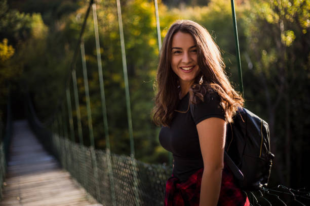 istock Woman crosses a suspension bridge 1212329292