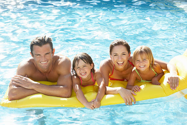 istock Young family playing in pool 121233149