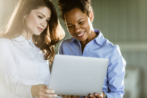 istock Happy businesswomen cooperating while working on laptop in the office. 1212331719