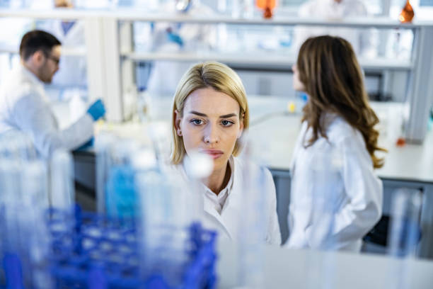 istock Young female scientist taking test tube in a laboratory. 1212332612