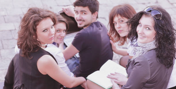 istock rear view.group of students preparing for lectures using laptop 1212332648