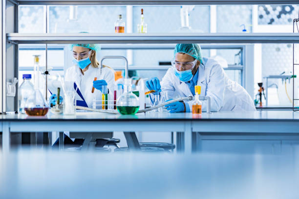 istock Two biotechnologists working on scientific research in laboratory. 1212332986