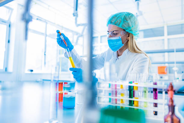 istock Young female chemist working with poisonous liquid in a laboratory. 1212333716