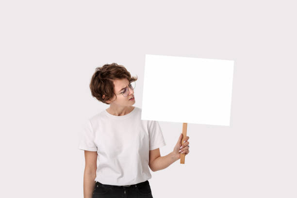 istock Concerned female protester holding empty signboard with copy space. 1212334149