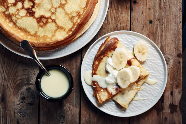 istock Thin pancakes, crepes with bananas and condensed milk. 1212335284