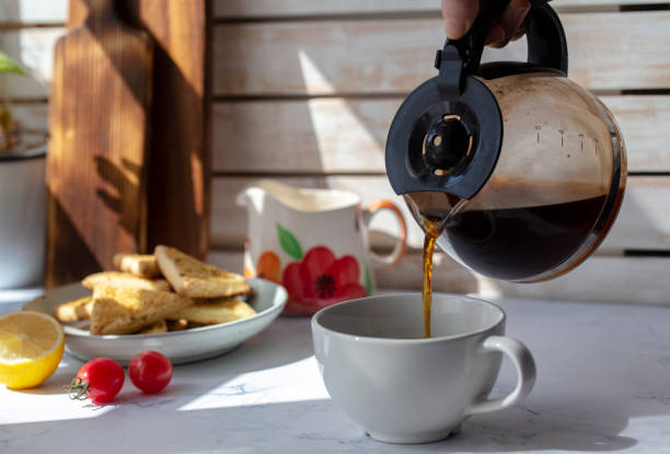 istock pouring black coffee into coffee cup 1212339000