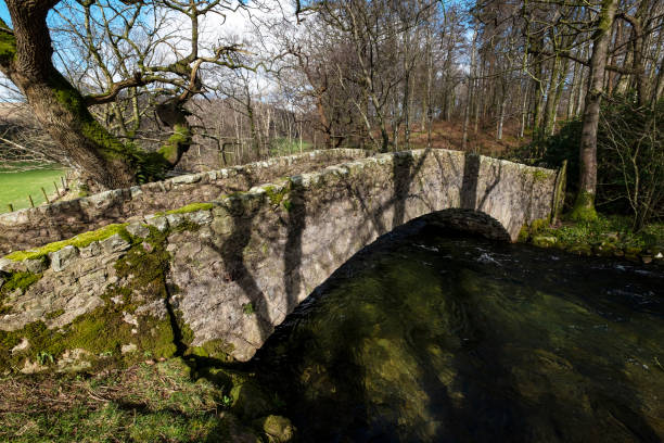 istock Ancient Packhorse Bridge over River Lund in English Lake District 1212339977