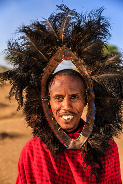 Portrait of warrior from Maasai tribe, Kenya, Africa African warrior from Maasai tribe wears an ostrich feather headdress, central Kenya, Africa. Maasai tribe inhabiting southern Kenya and northern Tanzania, and they are related to the Samburu. ostrich feather stock pictures, royalty-free photos & images