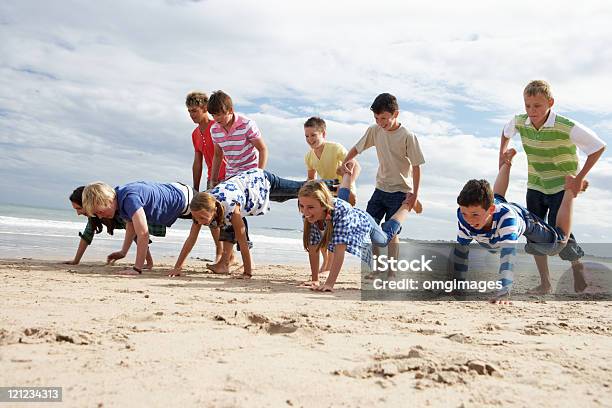 Teenagers Playing On Beach Stock Photo - Download Image Now - Summer Camp, Teenager, Beach