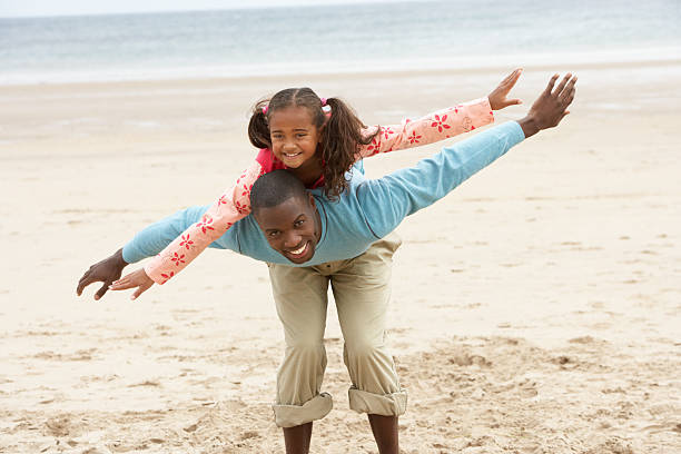 istock Father and daughter playing on beach 121234351