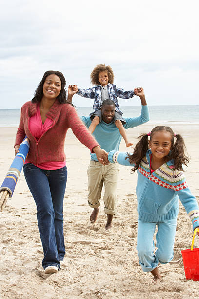 istock Happy family running on beach 121234355