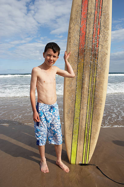 istock Teenage boy with surfboard 121234388