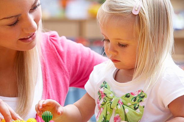 istock A lady and young girl are sat playing with balls 121234431