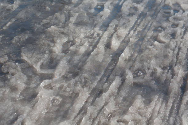 istock Spring puddles, snowdrifts, snow, mud and melted dirty water 1212344311