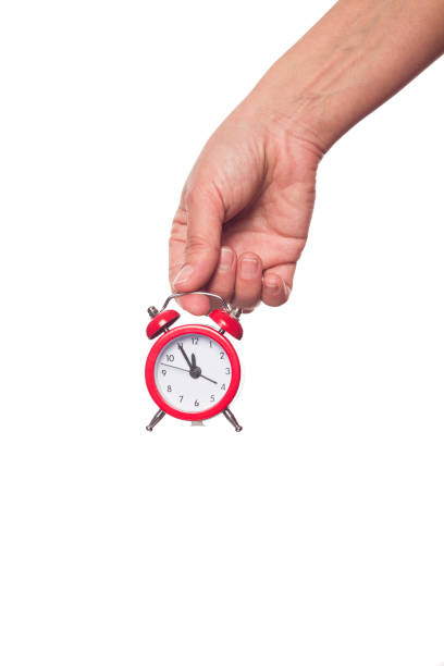 istock Woman holding a small red watch isolated on white background 1212345002