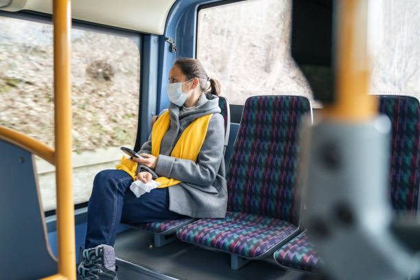 istock Coronavirus protection. Woman with a protective mask to avoid infectious diseases, looking away while in the bus shuttle. 1212345038