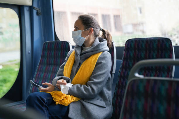 istock Coronavirus protection. Woman with a protective mask to avoid infectious diseases, looking away while in the bus shuttle. 1212345039