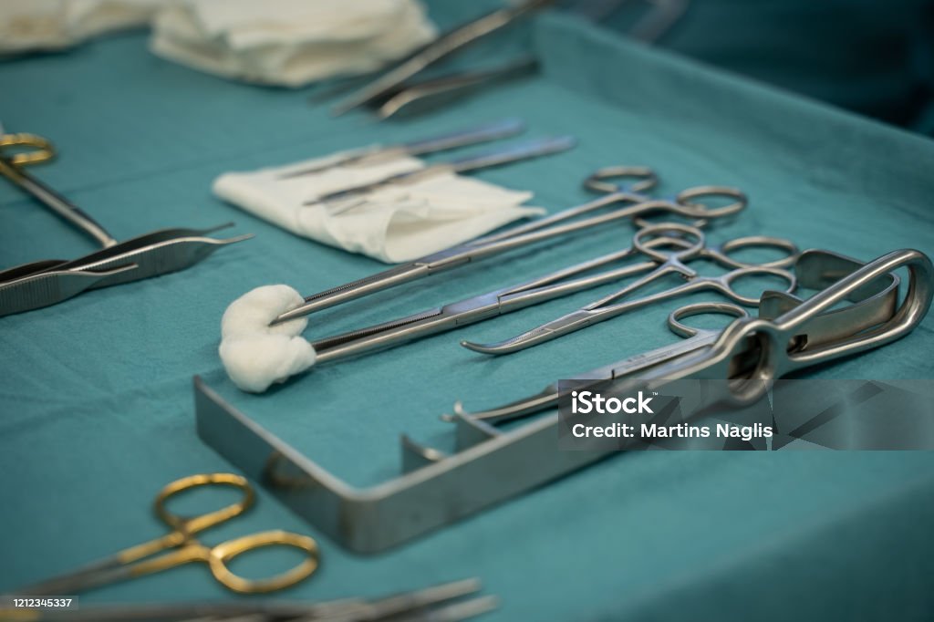 medical instruments on a blue table prepaired for surgery. medical instruments on a blue table prepaired for operation. Cosmetic surgery Blue Stock Photo