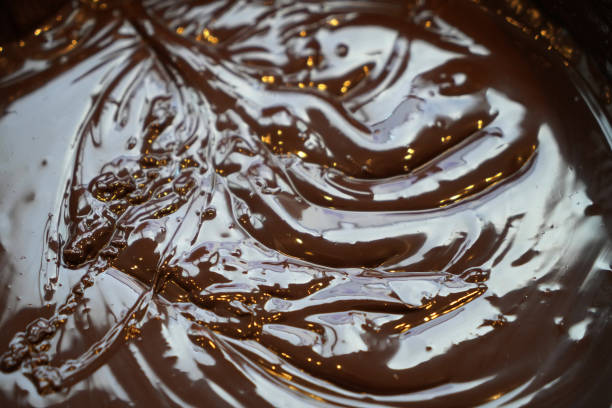 istock Melted chocolate swirl background drawn from top 1212348518