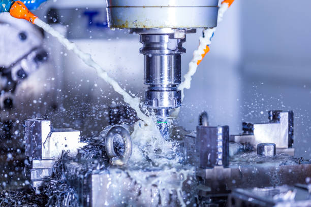 istock vertical cnc steel milling process with external water coolant streams, splashes and a lot of metal chips, high contrast 1212349352