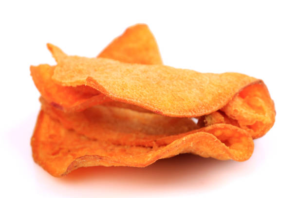 istock Tasty sweet potato chip isolated on white 1212349829