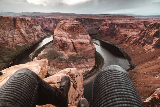 istock man sitting on the rock at the horseshoe bend 1212350947